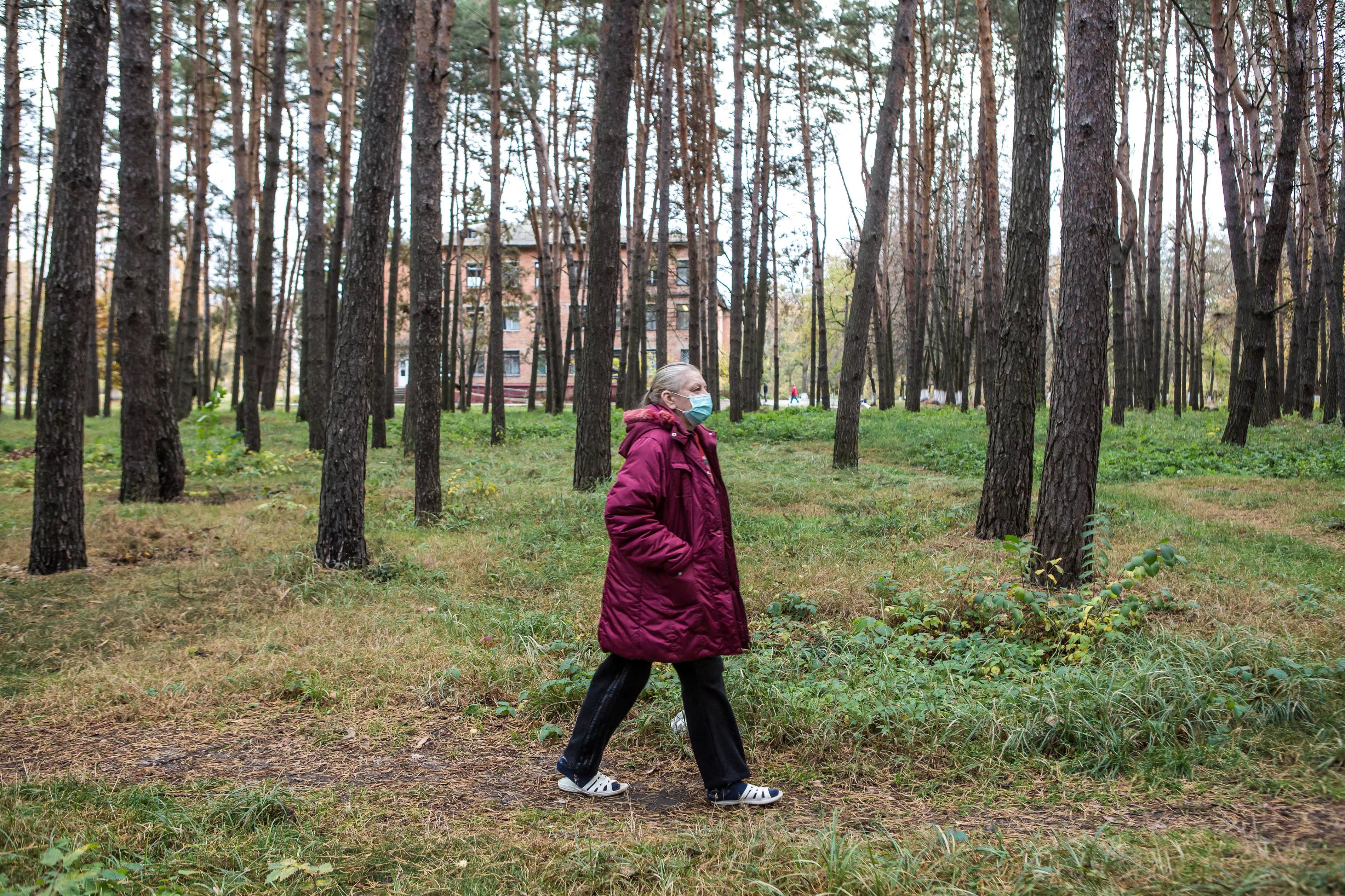 Halyna Uvarenko, 56, an MSF patient with multidrug-resistant TB (MDR-TB), walks in the forest around the Zhytomyr Regional TB Dispensary where she is receiving treatment. 
