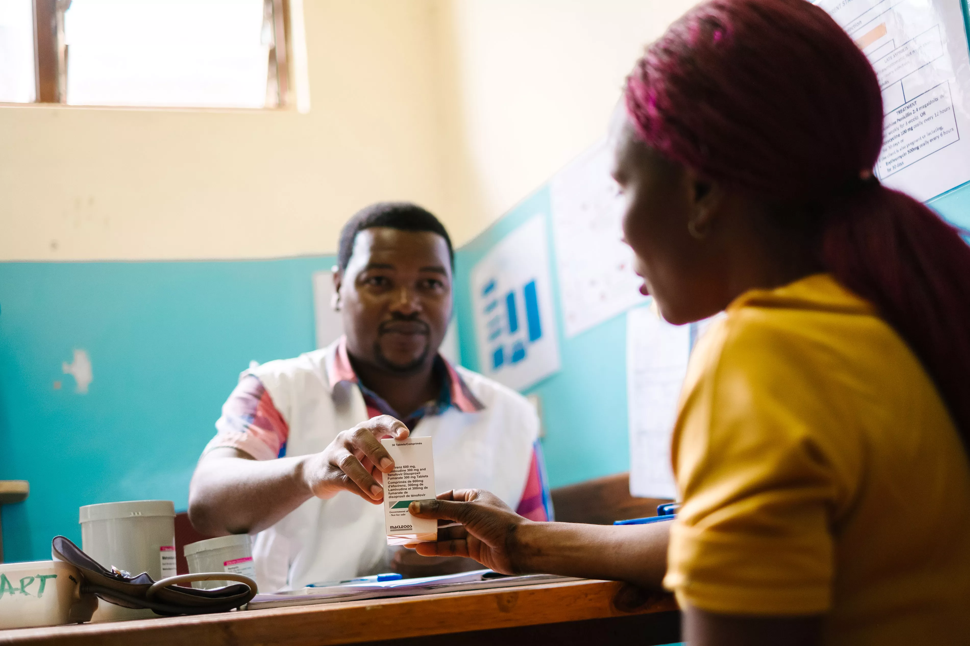 MSF clinical officer James Mponya gives a box of antiretrovirals to a sex worker who is living with HIV at MSF’s one-stop-clinic, Dedza district hospital.