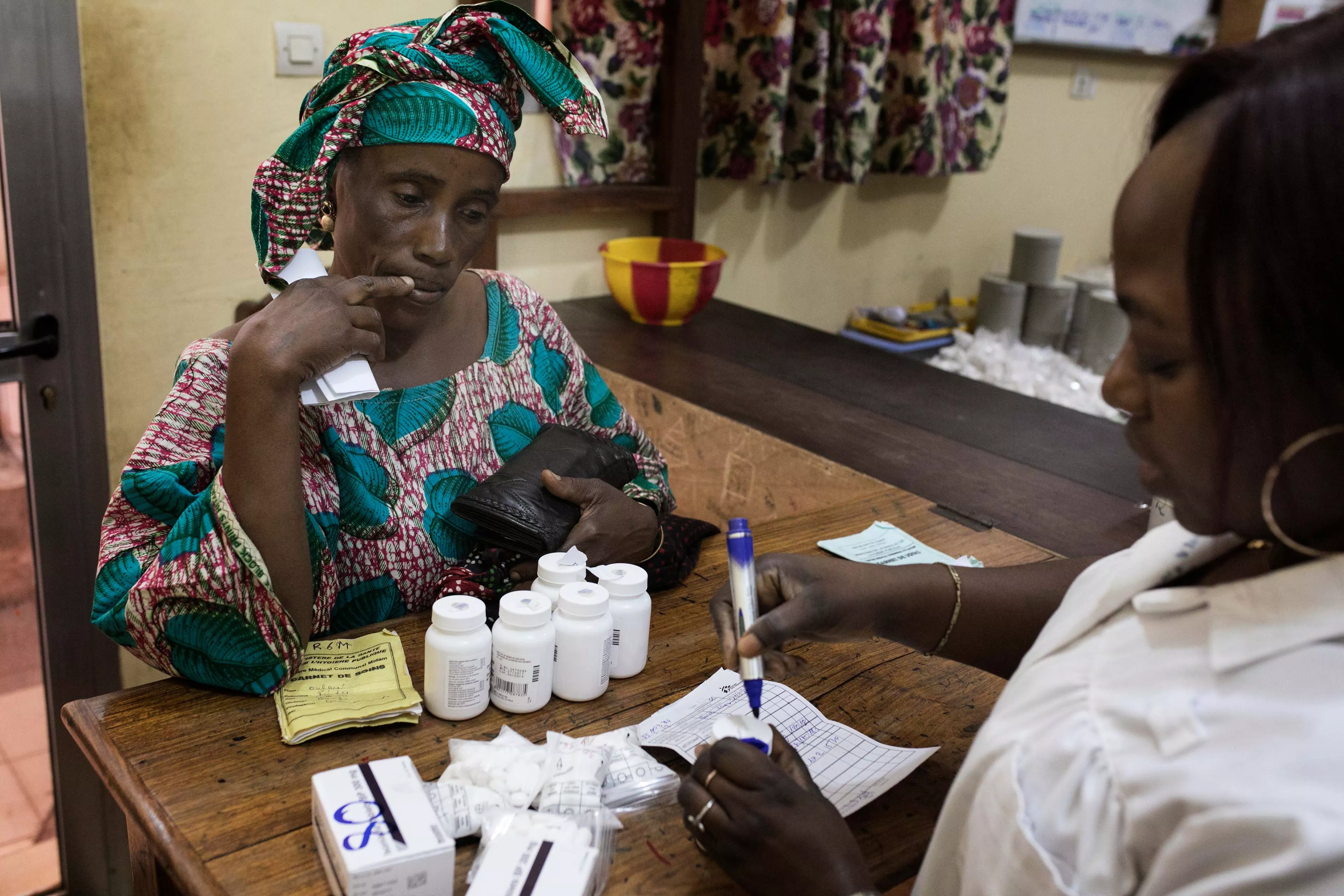 Finda collects her six months of ART and related drugs at MSF-supported pharmacy as part of her months consultation at the MSF-supported HIV outpatient department at Matam health centre, Conakry, Guinea