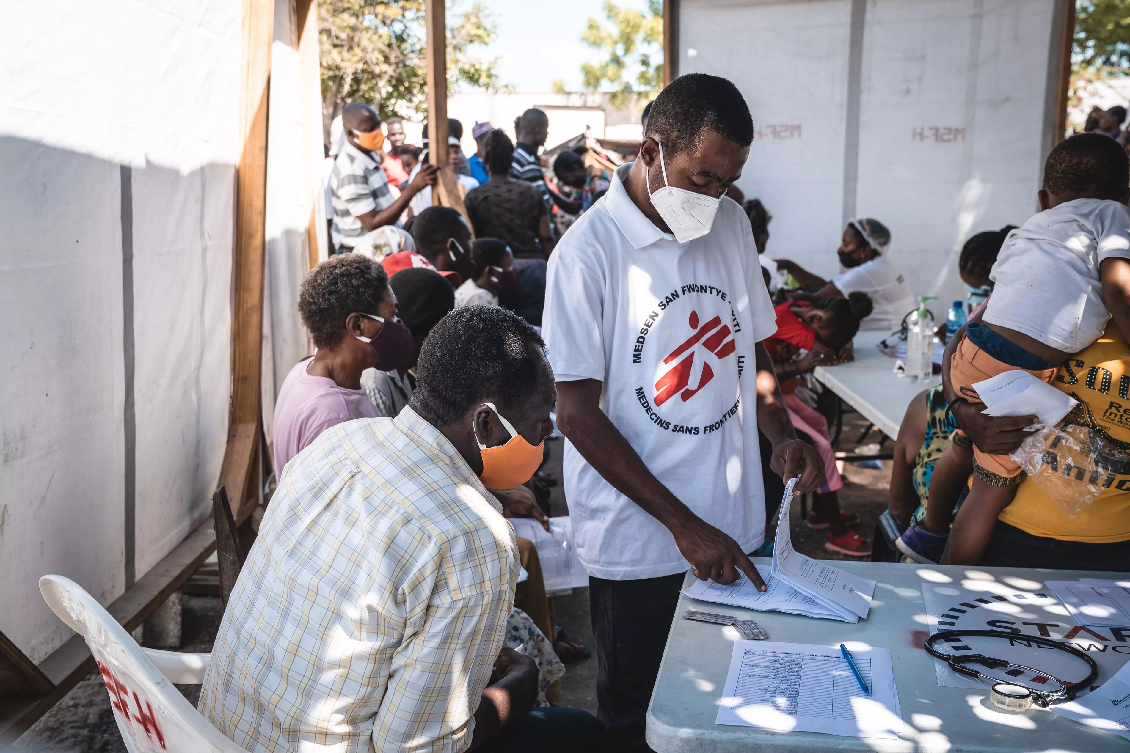 MSF Medical Doctor, Mayard Mitial, consults with a patient in St Yves, Delmas 5 displaced persons camp in Port au Prince, Haiti, where around 1,100 people live.