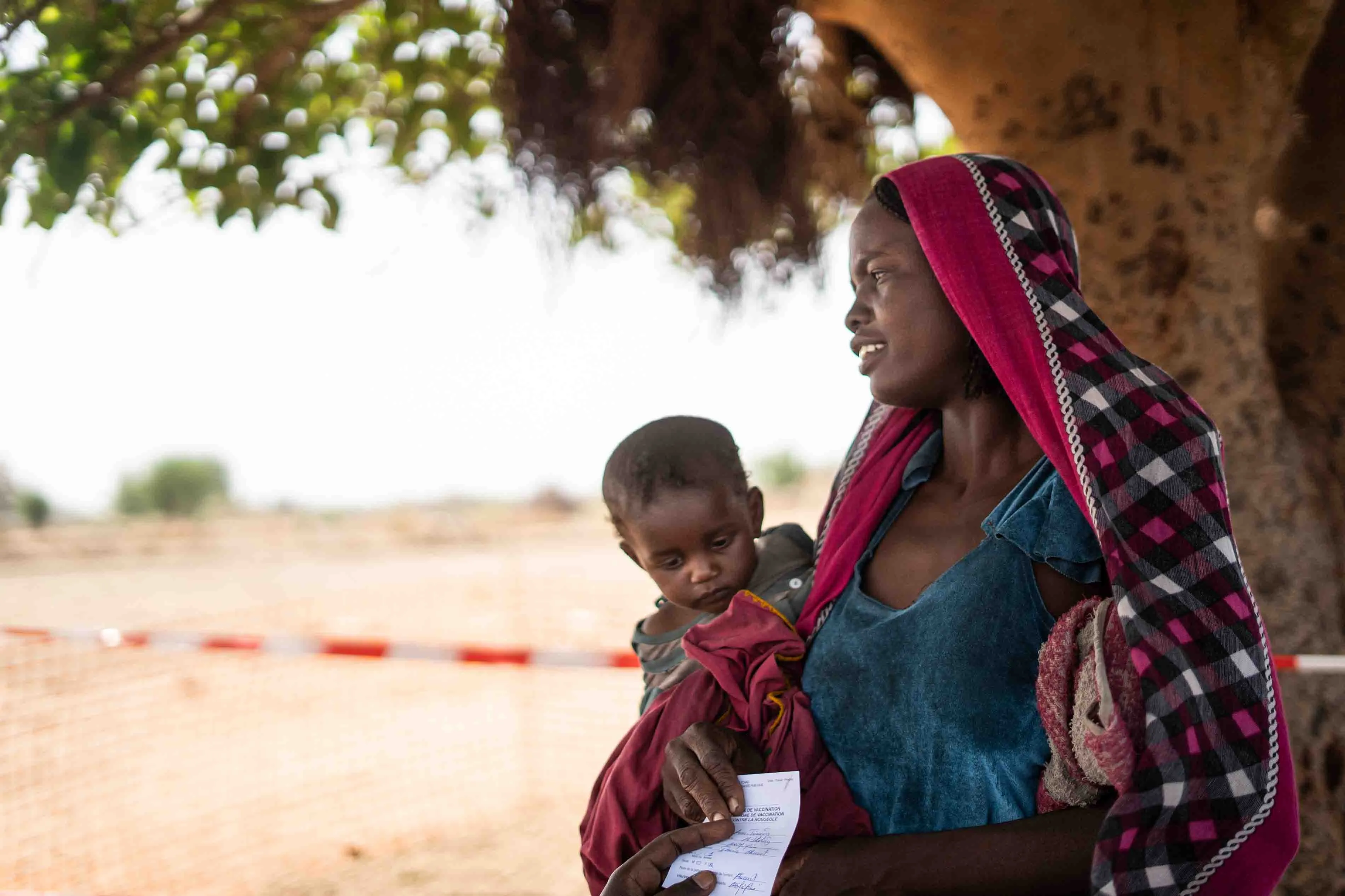 Zara Ahmat, 20, with her baby, Aba Abdulaziz, 1, just vaccinated against measles, Chad, 2019.