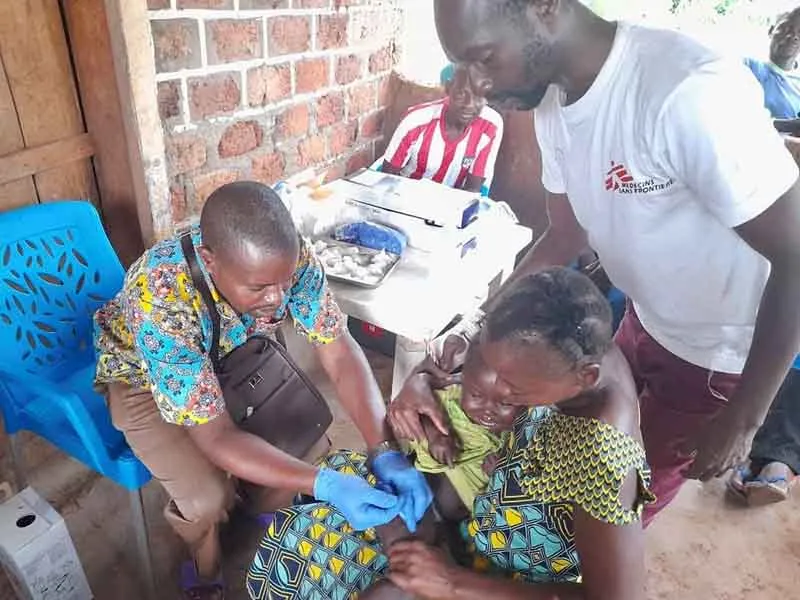 A baby is vaccinated against measles and whooping cough by a member of MSF's emergency team in Satema, in the south of Central African Republic. Photo credit: Ahmed Hassan Sami/MSF