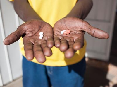 A man holds antiretroviral drugs at an activist meeting in Soshanguve, a township outside of Pretoria on April 16, 2015