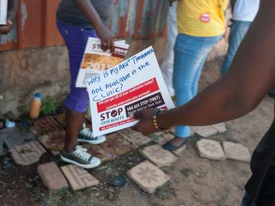 A woman holds a sign at the Stop Stock Outs (SSP) activist meeting in Soshanguve, a township outside of Pretoria on April 16, 2015.