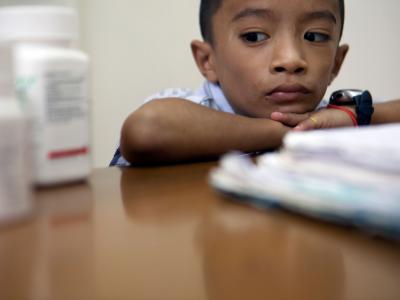 A boy with HIV is examined at Dawei clinic.