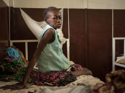 "I don’t have money for medical treatment so I did not seek help for a long time." Cynthia DOUNKEL, 26 years old, is hospitalized for the second time within a month in Hôpital communautaire in Bangui. She was referred from the MSF clinic in the displaced camp Mpoko at the airport of Bangui. She is HIV positive, has Tuberculosis and suffers from Kaposi's sarcoma. She is three months pregnant. 09 July 2016 - Hôpital communautaire, Bangui, Central African Republic. Photograph by Alexis Huguet