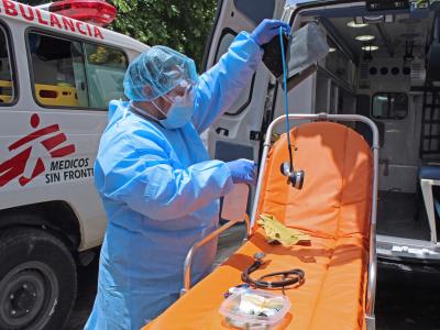 Nursing assistant of MSF ambulance service disinfects equipment after an intervention in the city of Soyapango.