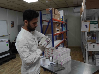 MSF pharmacy manager at the Sinuni,Iraq,  general, hospital organizing pharmacy items.