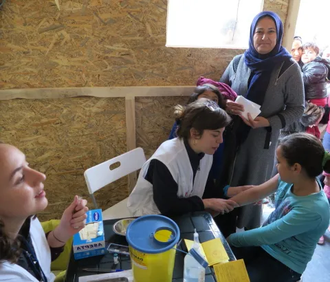 Child receiving vaccination in MSF clinic