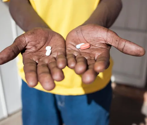 A man holds antiretroviral drugs at an activist meeting in Soshanguve, a township outside of Pretoria on April 16, 2015