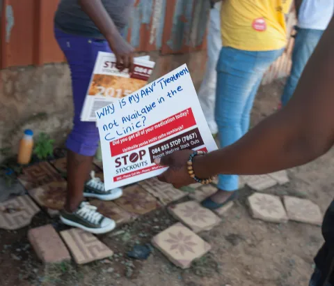 A woman holds a sign at the Stop Stock Outs (SSP) activist meeting in Soshanguve, a township outside of Pretoria on April 16, 2015.