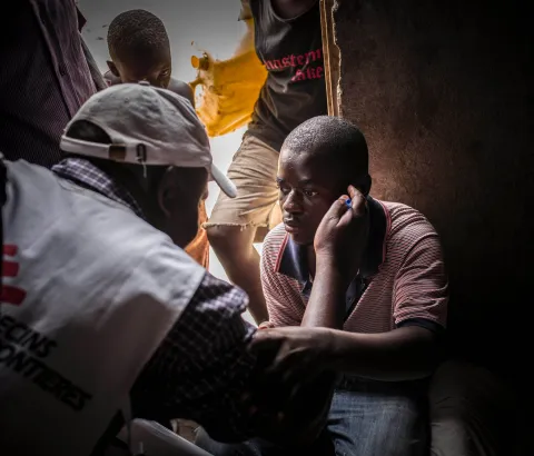 MSF provides ambulatory and door to door testing for HIV. This man was born with aids, he led a normal life thanks to his medicine until he got to the university. People made fun of him for taking pills, so he stopped taking them. He his now deaf and blind. His uncle communicates with him by writting on his arm.