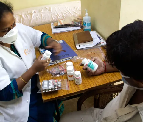 MSF Nurse dispensing 3rd line ARTs to patient living with HIV.