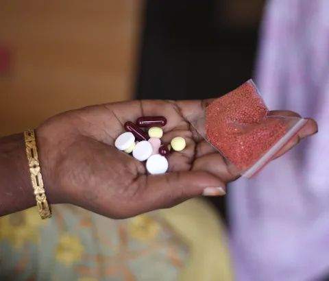 Shanti (name changed) is a 38 year old semi-literate woman living in Mumbai. She has been living with HIV and multidrug resistant tuberculosis (MDR-TB) for the past 5 years. Here, she displays her daily dosis of medication. Photograph by Bithin Das