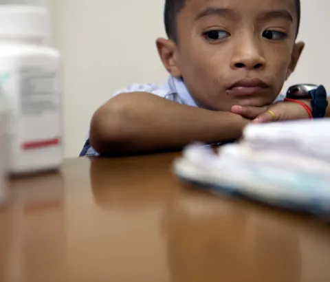 A boy with HIV is examined at Dawei clinic.