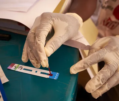 HIV activist Boubacar Camara tests a man for HIV at the Médecins Sans Frontiers (MSF) mobile clinic in the neighbourhood of Tombolia, Conakry, Guinea on March 18, 2016. 