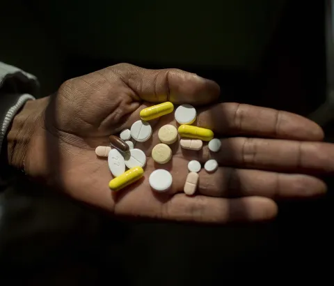 Simphiwe holds his medication, he takes up to 26 pills a day to treat XDR-TB. Here he holds his morning selection, which includes delamanid, one of the newest DR-TB drugs, which Simphiwe is taking for the first time today.