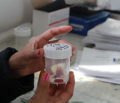 A DR-TB patient holding her daily dose at the Directly Observed Therapy corner, where patients pick up medicines for daily intake, in the Chimbay district of Karakalpakstan, Uzbekistan.