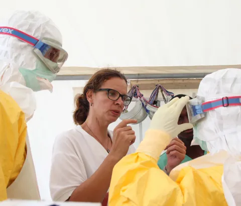 Emergency coordinator Anja Wolz (centre) reminds MSF International President Dr Joanne Liu (right) to adjust goggles so that it fits comfortably and securely. Photograph by P.K. Lee
