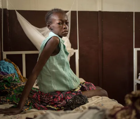 "I don’t have money for medical treatment so I did not seek help for a long time." Cynthia DOUNKEL, 26 years old, is hospitalized for the second time within a month in Hôpital communautaire in Bangui. She was referred from the MSF clinic in the displaced camp Mpoko at the airport of Bangui. She is HIV positive, has Tuberculosis and suffers from Kaposi's sarcoma. She is three months pregnant. 09 July 2016 - Hôpital communautaire, Bangui, Central African Republic. Photograph by Alexis Huguet