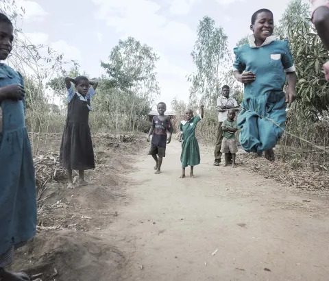 Gloria Chipasula, 11 years old MSF's HIV and TB positive patient stands in in the middle of the road (green dressed) as she plays with her young relatives and village's friends.