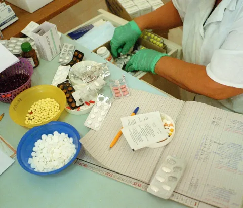 A nurse dispensing TB medication inside Colony 3 TB prison.