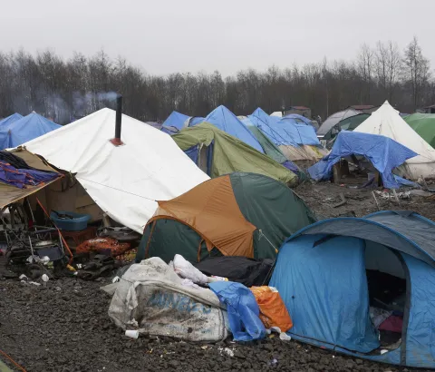 Tents and debris litter the site of a the refugee camp in Grande Synthe near Dunkirk in northern France. Some 2,500 refugees have settled here whilst they attempt to cross to the United Kingdom to seek asylum. Grande Synthe, Dunkirk: A Gill visits the refugee camps of Calais and Grande Synthe in Dunkirk. Photograph by Jon Levy