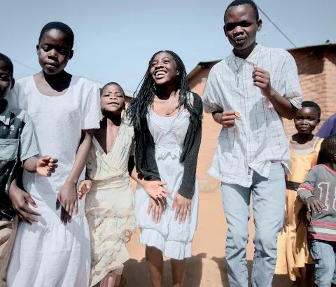 Mbulumbuzi Health Centre. Adolescent HIV project. Patients perform a dance to start the "six-months-meeting day" in which the supporting staff welcome new members and monitor all the girls and boy who already joined the program.