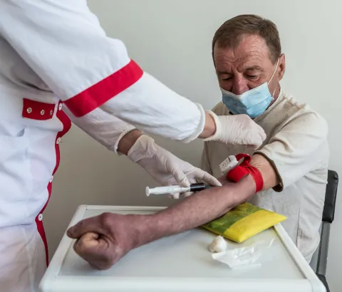 A nurse conducts a blood test on a DR-TB patient Dmitri Karpuk (name changed), 61 at the TB facility in Novograd-Volynsk district, Zhytomyr region, Ukraine.
