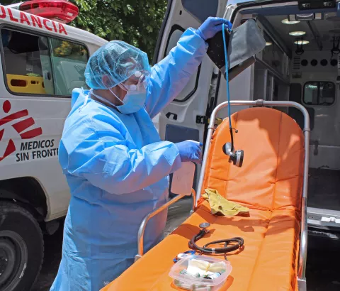 Nursing assistant of MSF ambulance service disinfects equipment after an intervention in the city of Soyapango.