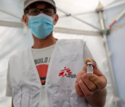 Jérôme Tognotti, MSF nurse supervisor, holding a vial of COVID vaccine used by teams to vaccinate homeless and migrant people